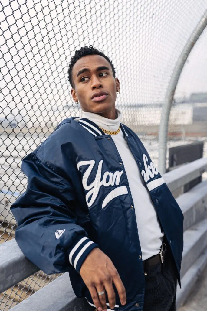 man wearing blue bomber jacket