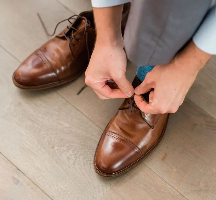 man wearing brown dress shoes