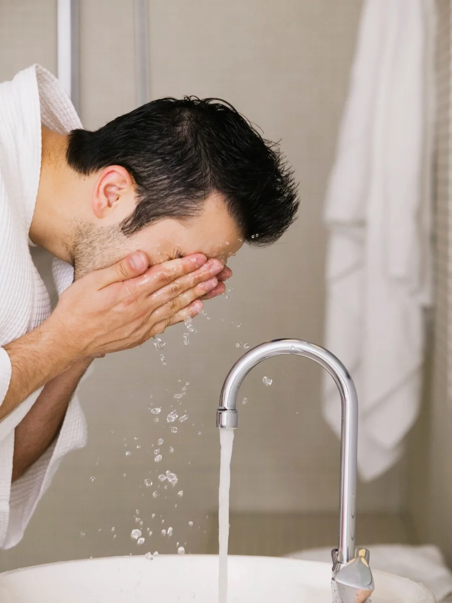 Man washing his face